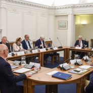 People sitting around a boardroom style table.