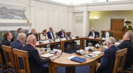 People sitting around a boardroom style table.