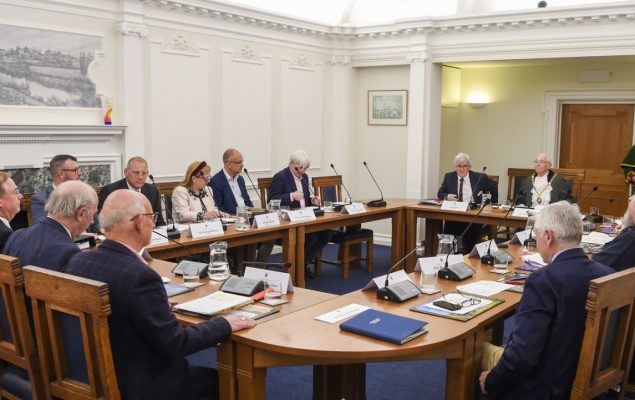 People sitting around a boardroom style table.